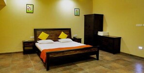 A bedroom with a wooden bed, two nightstands, a dresser, and a cabinet. - Casa Paradise Resort (Waghoriya)