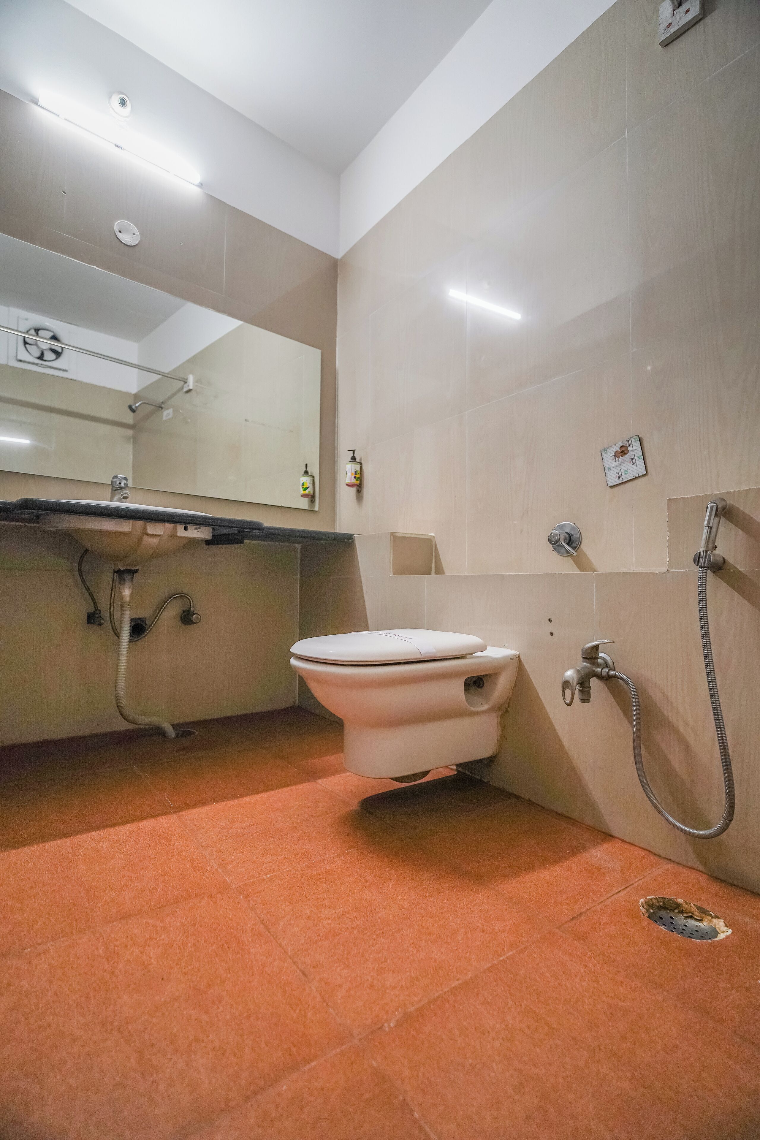 A bathroom with a toilet, sink, and shower.
