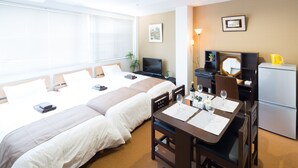 A hotel room with two beds, a dining area with a table and chairs, a television, a refrigerator, and a window with blinds. - Sakamoto Building 7F (Osaka)