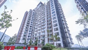 A high-rise residential building with multiple balconies, surrounded by greenery and modern architecture. - OYOHome 89448 Extraordinary Studio (Genting Highlands)