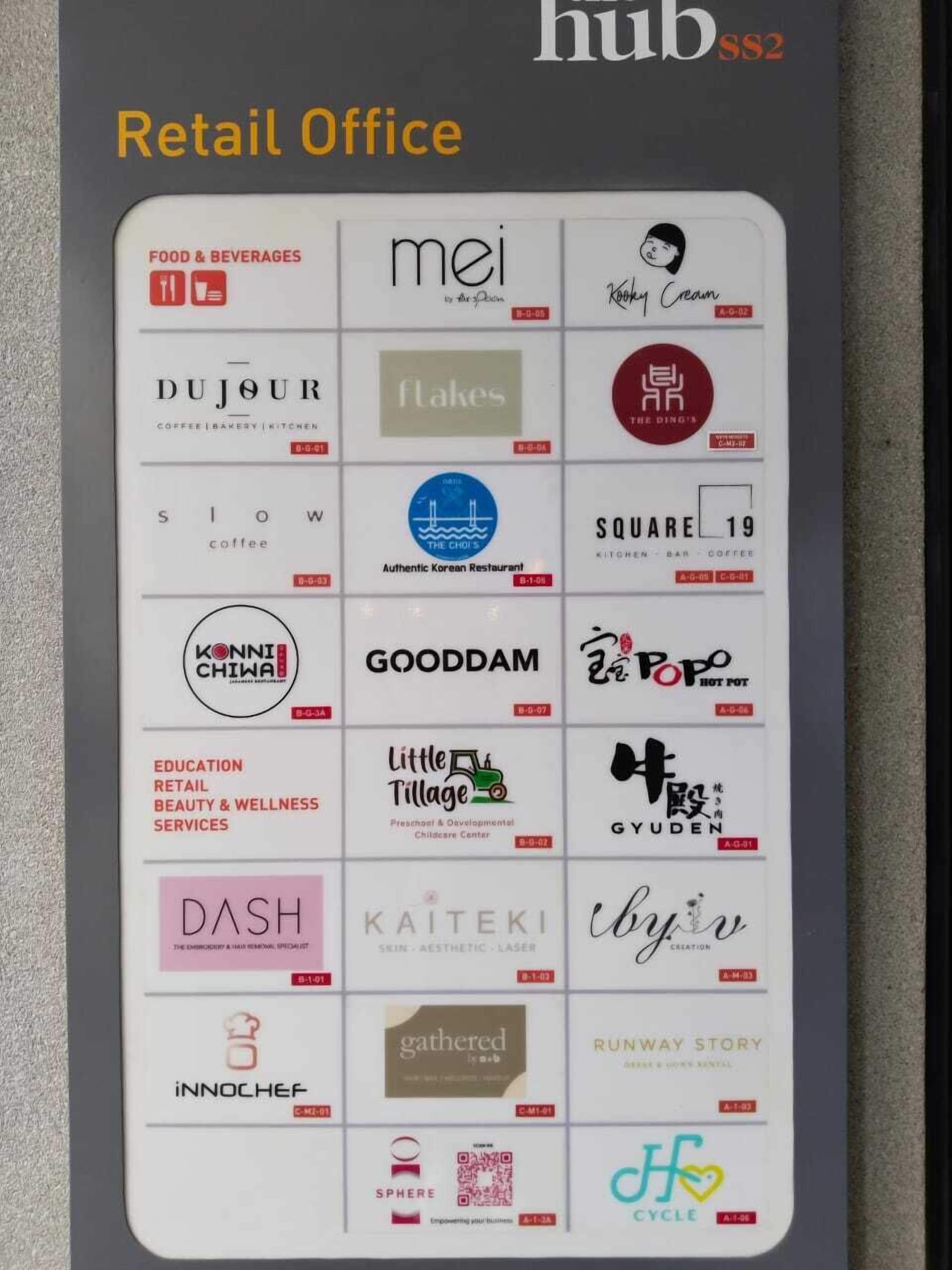 A retail office with a grid of business cards for various local businesses, including food, beverages, and services.