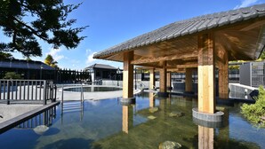Een traditioneel Japans onsen met houten constructies en helder water.