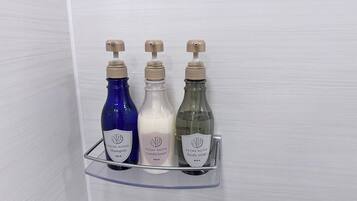 Three bottles of ESTHE ROYER products on a clear shelf.