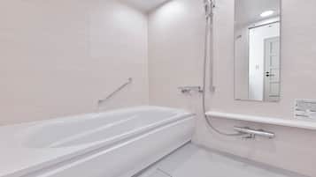 A modern bathroom with a white bathtub, a shower with a handheld showerhead, and a wall-mounted mirror.