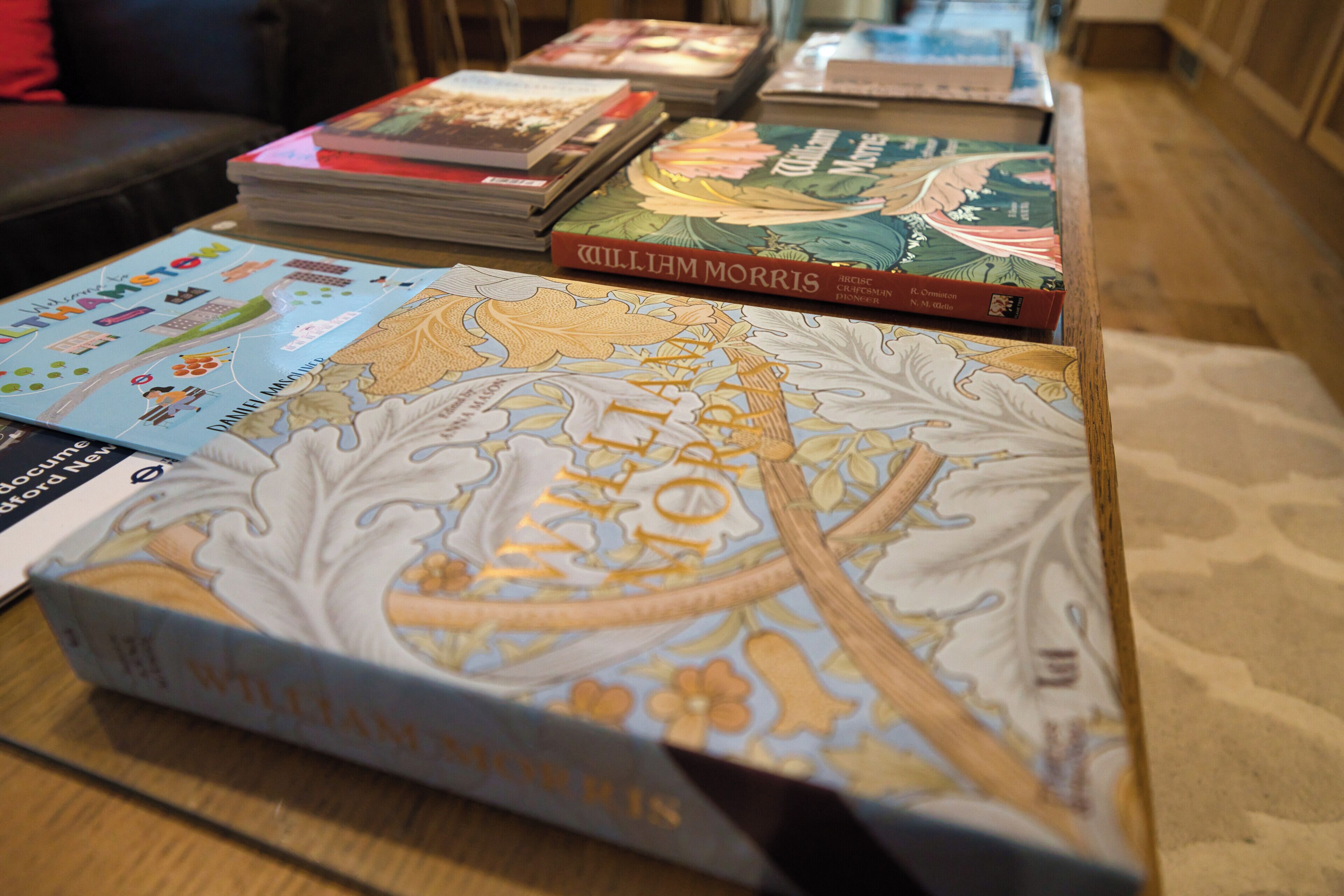 A table with various books, including a prominently displayed book titled 'William Morris'.