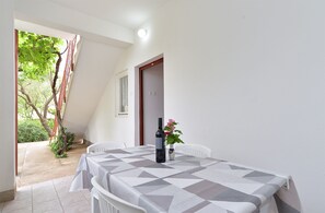Enjoy a romantic meal for two in this intimate outdoor dining area, complete with a beautifully set table and a lovely view.