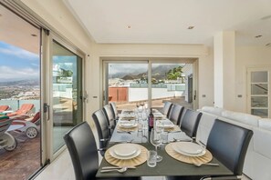 A dining area with a table set for six, overlooking a scenic view. - Casa Bella Vista, Stunning Villa with 4 Bedrooms, 3 Bathrooms AC & Gym etc (Costa Adeje)