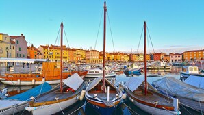 A marina with various boats docked, surrounded by colorful buildings. - Apartment 616/1479 (Istria - Rovinj), 500m from the beach (Rovinj)