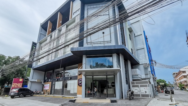 A multi-story building with a ground-level commercial space and upper residential units.