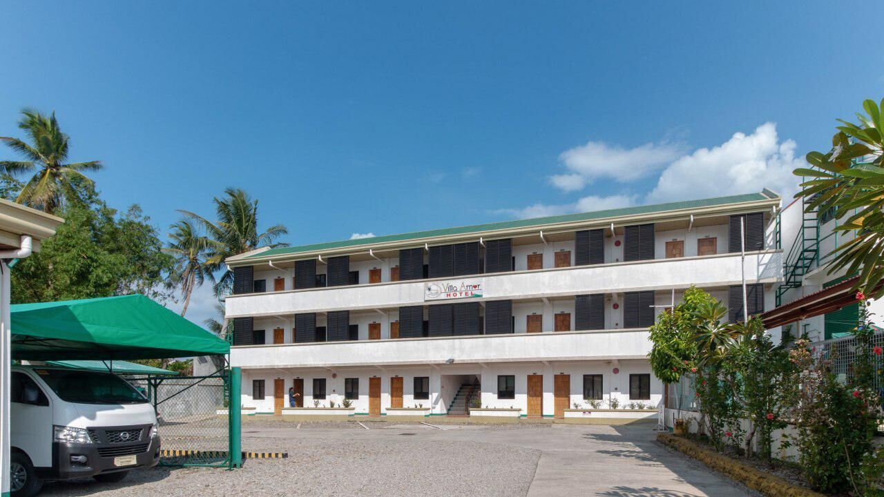 A two-story building with a sign reading "Villa Amore."
