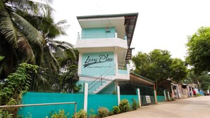 A building with a sign reading "Long Place" and a staircase leading to the entrance. - RedDoorz @ Dinagpan Street Coron (Coron)