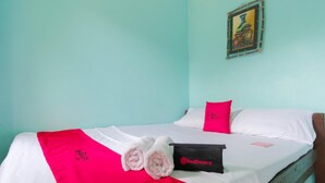 A bed with white bedding, a red blanket, and a pillow with a RedDoorz logo. - RedDoorz @ Dinagpan Street Coron (Coron)