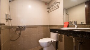 A bathroom with a toilet, sink, and shower. - RedDoorz near Giap Bat (Hanoi)