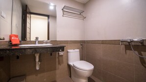 A bathroom with a sink, toilet, and shower. - RedDoorz near Giap Bat (Hanoi)