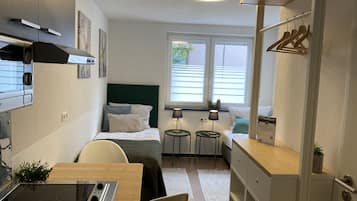 Standard Double Room | Living area | 32-inch flat-screen TV with cable channels, TV, toys