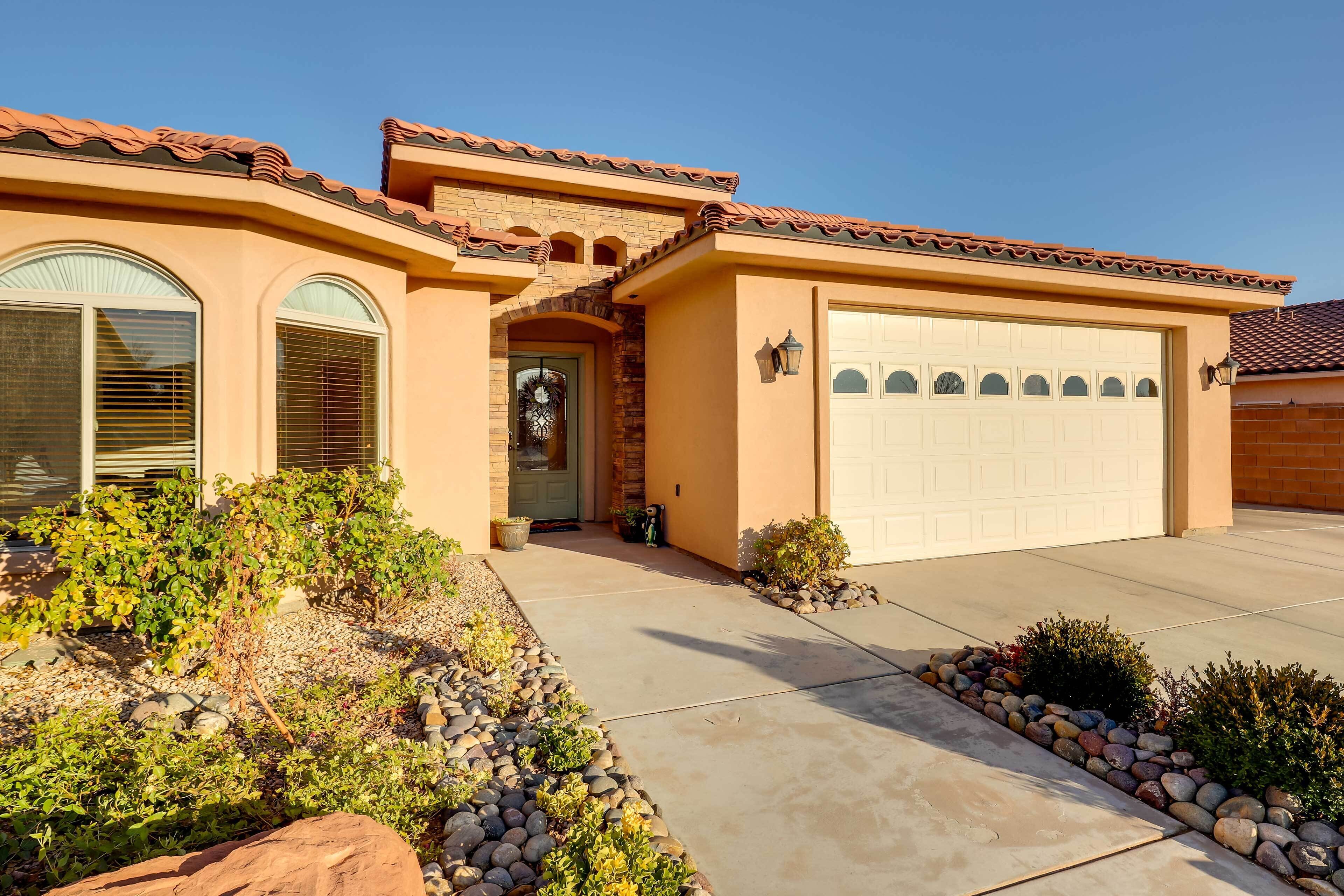 A single-story house with a garage, a front entrance with a door, and a small porch area.