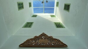 A room with a skylight, a decorative wooden panel, and multiple ventilation grilles. - Dar El Kif La Marsa (La Marsa)
