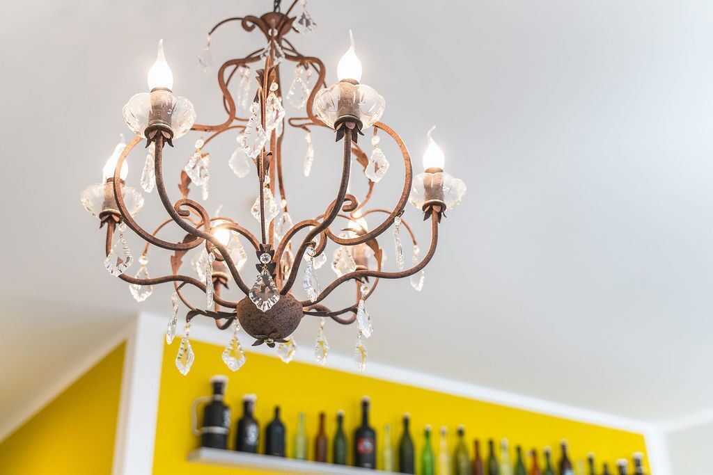A chandelier with multiple arms and crystal decorations.