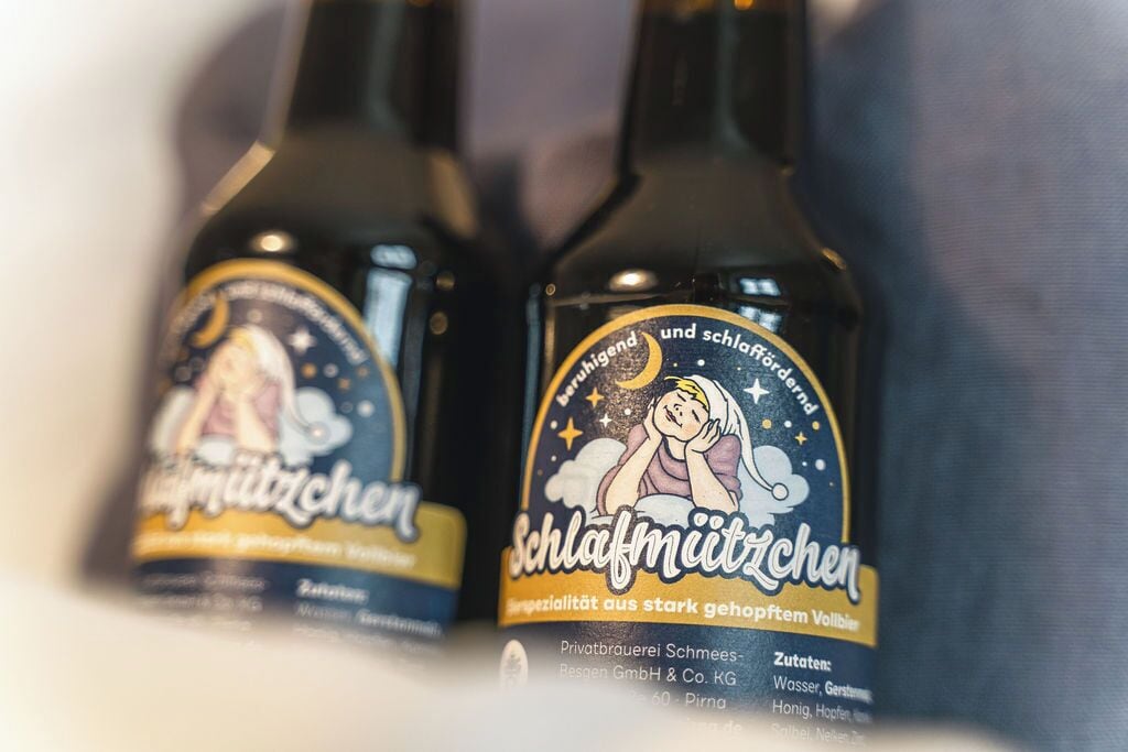 Dos botellas de una bebida con etiqueta que muestra una luna y estrellas, y texto en alemán.