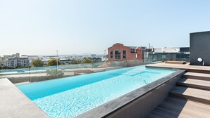 A rooftop swimming pool with a clear view of the cityscape in the background. - Docklands 409 (Cape Town)