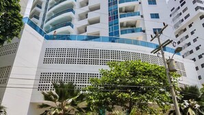 A tall, modern hotel with multiple balconies and a central atrium. - Ocean view • Wonderful sunsets • Beach • Pool 1206 (Cartagena)