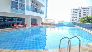 A swimming pool with a checkered pattern, surrounded by a stone deck and metal railings. - Ocean view • Wonderful sunsets • Beach • Pool 1206 (Cartagena)
