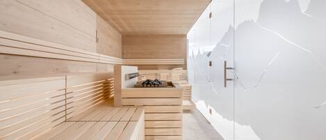 A modern spa with wooden benches and a sauna area.