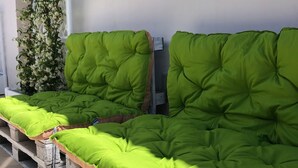 A row of green cushioned benches on a wooden platform, likely part of a seating area. - Semi-detached villa a few steps from the sea (San Foca)