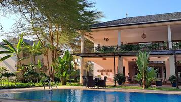 A poolside area with outdoor seating and a covered patio.