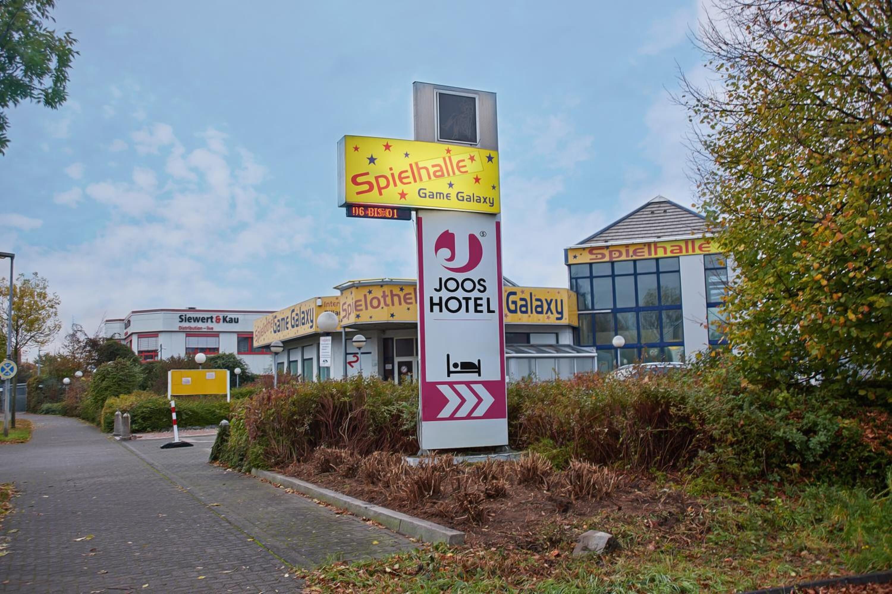 A hotel sign with 'Spielhalle' and 'JOOS HOTEL' logos, indicating a gaming and hotel facility.