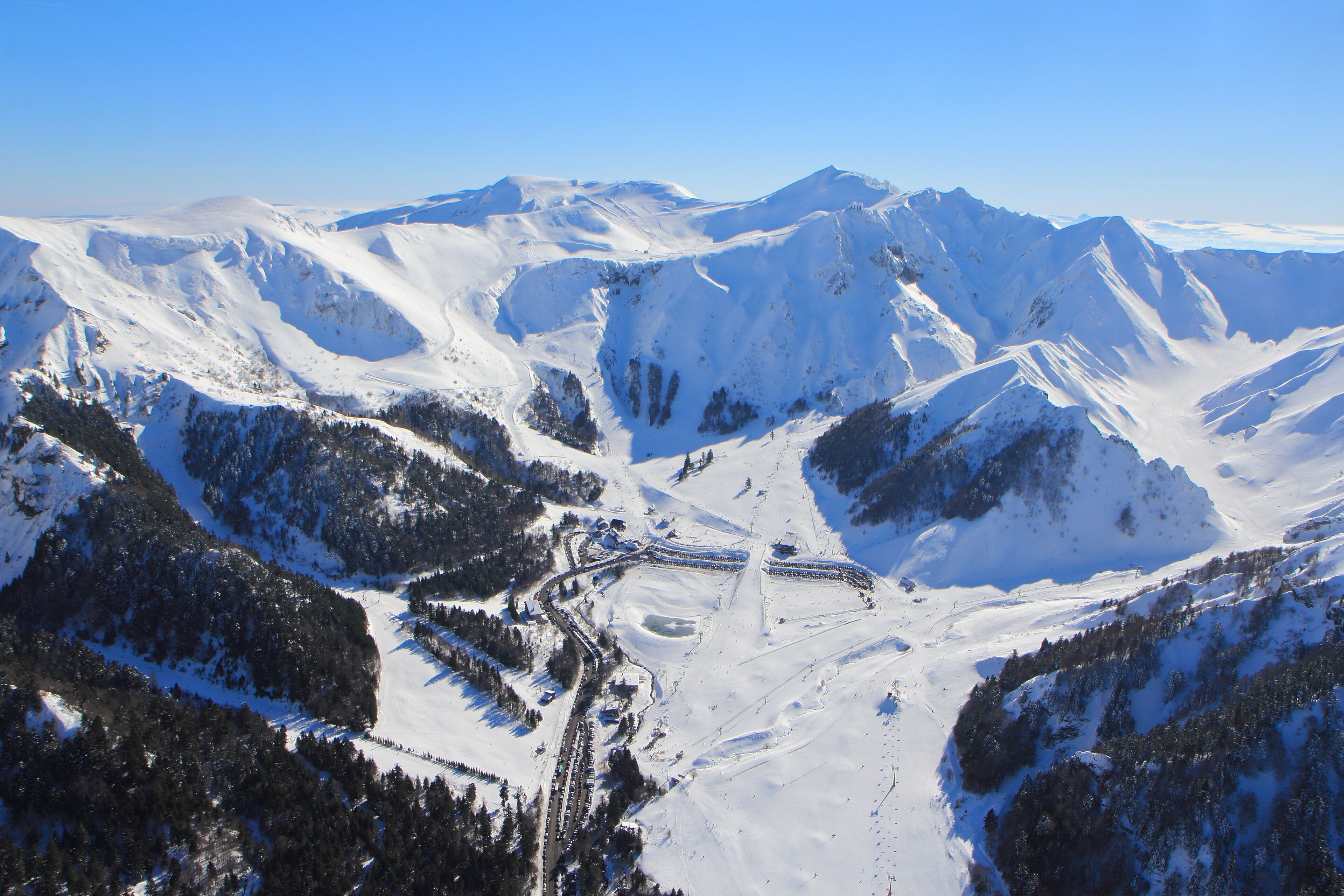A snow-covered mountain landscape with ski trails and lodges.