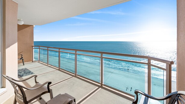 A balcony with a clear view of the ocean, a table, and two chairs. - Bahama Sands 1106, 3 BR Ocean Front Luxury Condo with Indoor Outdoor Swimming Pool, Hot Tub, Lazy River and Kiddie Pool (North Myrtle Beach)