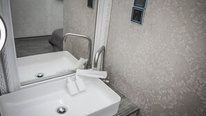 A bathroom with a white sink, a mirror, and a towel rack. - Summer night (Tainan)