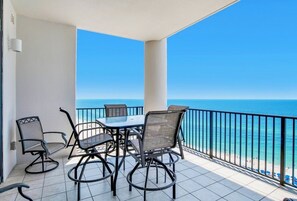 Enjoy ocean views from this balcony with a dining area.
