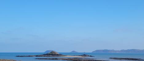 A rocky coastal landscape with clear skies.