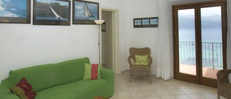 Apartment, 2 Bedrooms (La Gabbiana) | Living room | Flat-screen TV