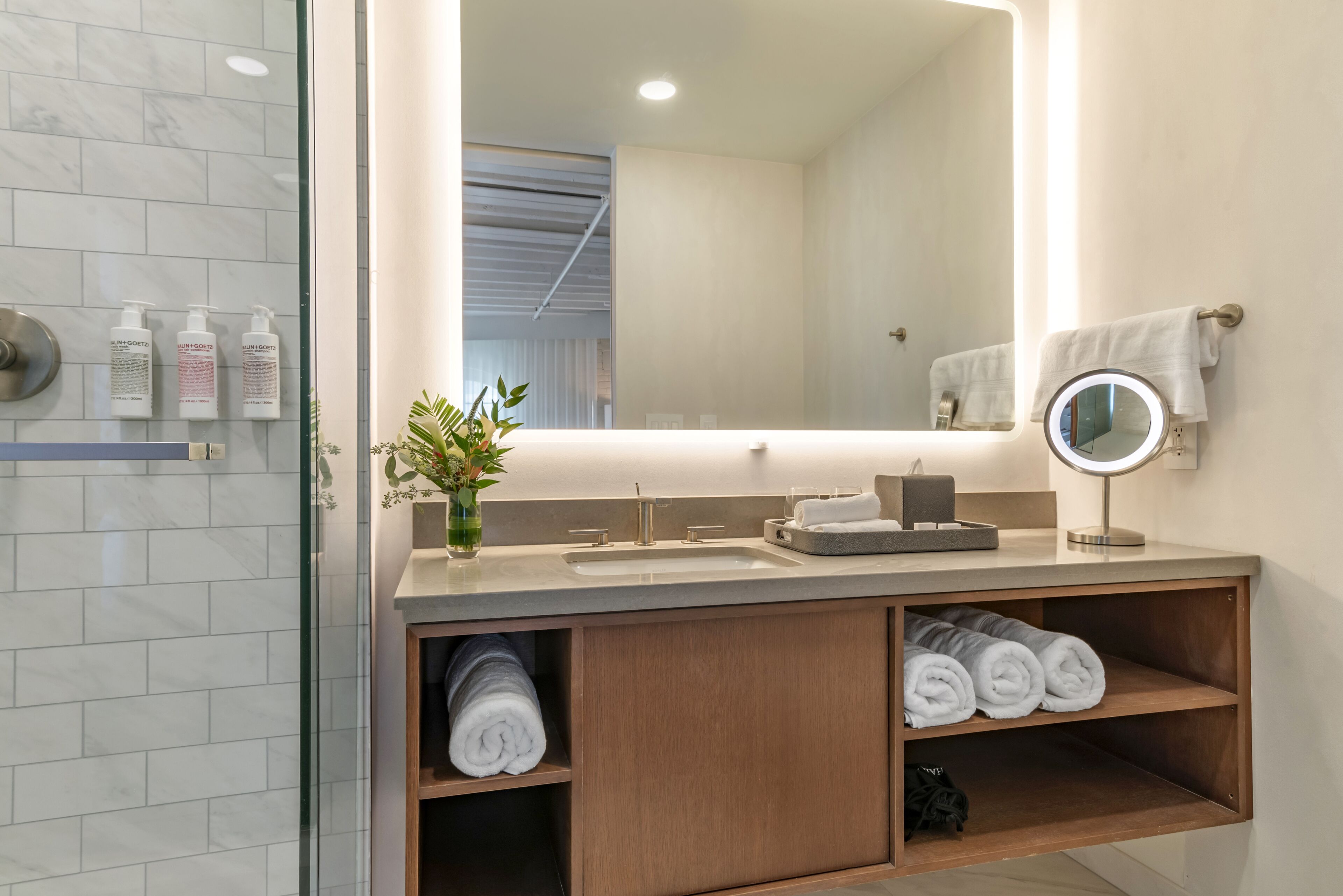 shower, designer toiletries, hair dryer, towels