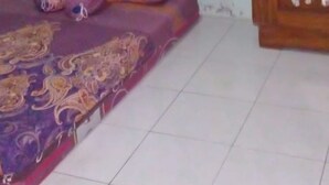 A bedroom with a bed, a wooden wardrobe, and a window with curtains. - Pak Pur Homestay (Kasihan)