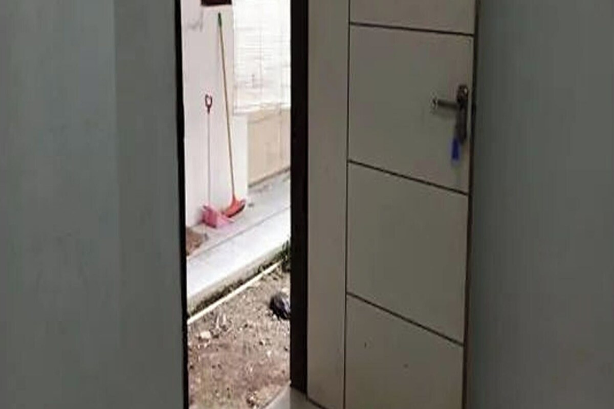 A room with a tiled floor, a closed door, and a visible window.