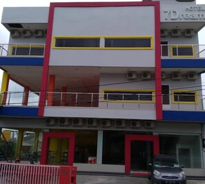 A multi-story hotel with a modern design, featuring balconies, air conditioning units, and a prominent entrance. - 7 Dream Hotel (Palembang)