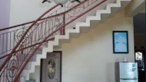 A staircase with a red railing leading to an upper floor. - Villa Panderman View (Batu)