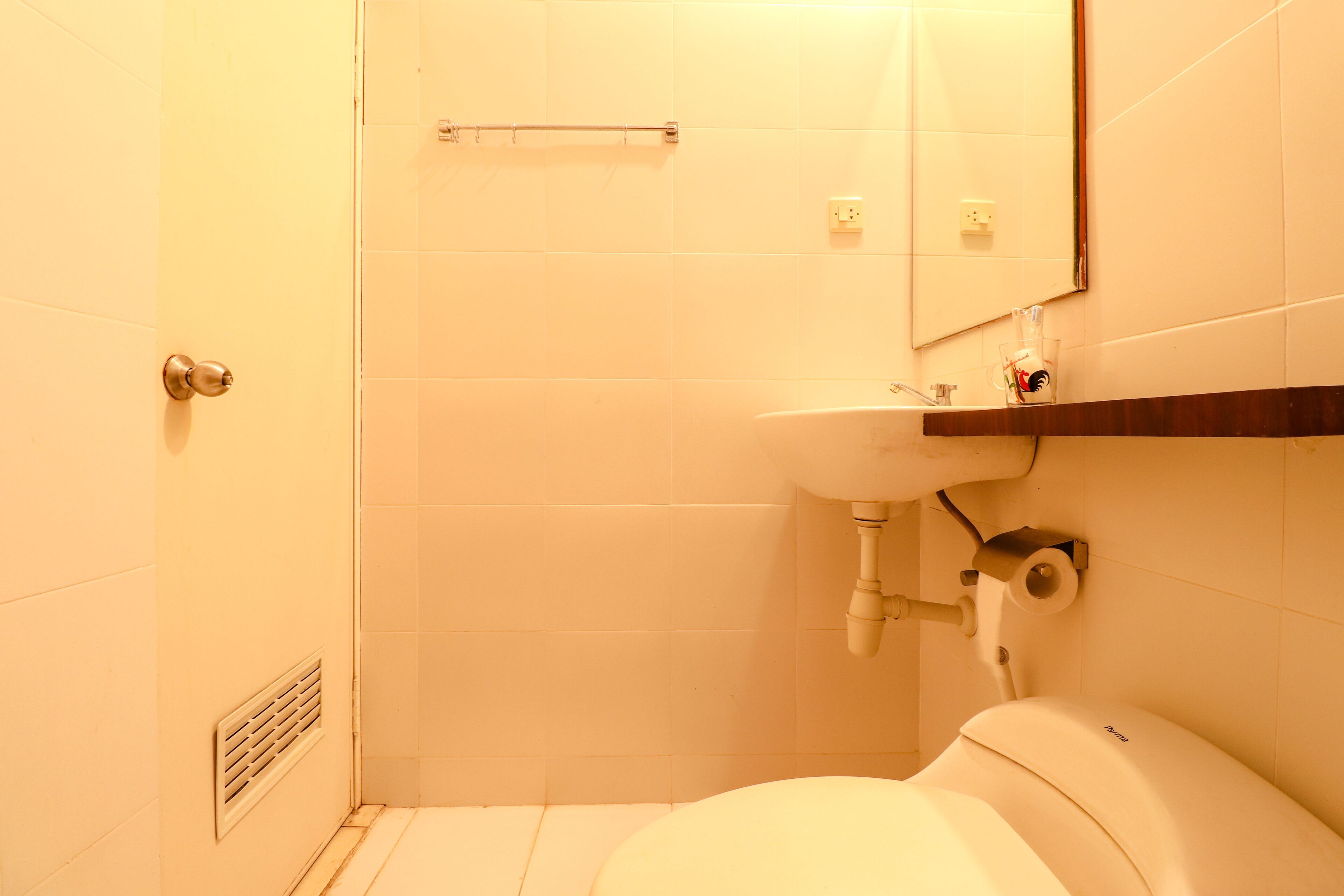 Une salle de bain comprenant des toilettes, un lavabo et un espace douche.