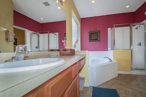 A bathroom with two sinks, a bathtub, and a shower. - Emerald_island_2718 (Kissimmee)