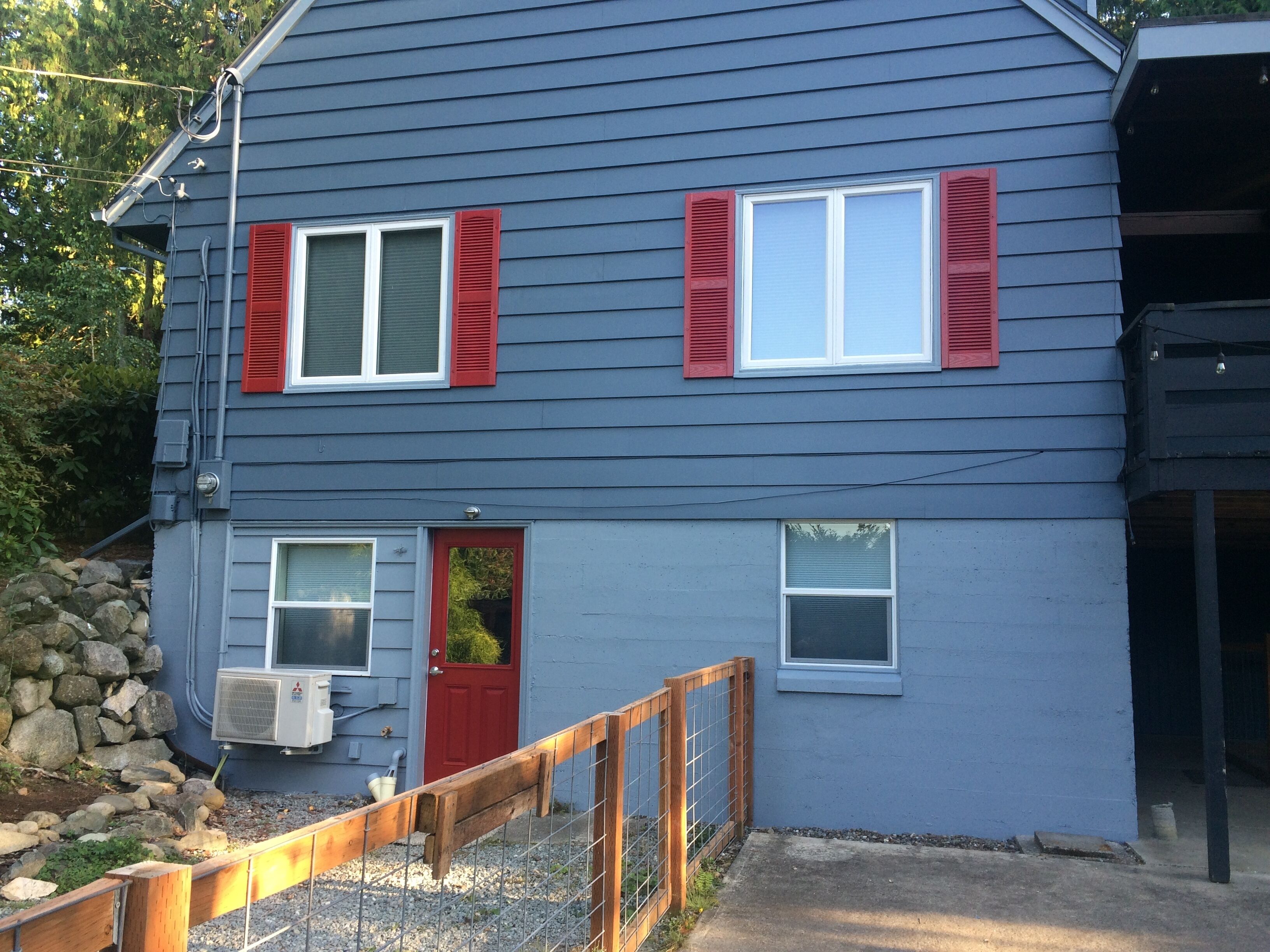 Red private entrance door to Five Cedars Retreat on basement level.
