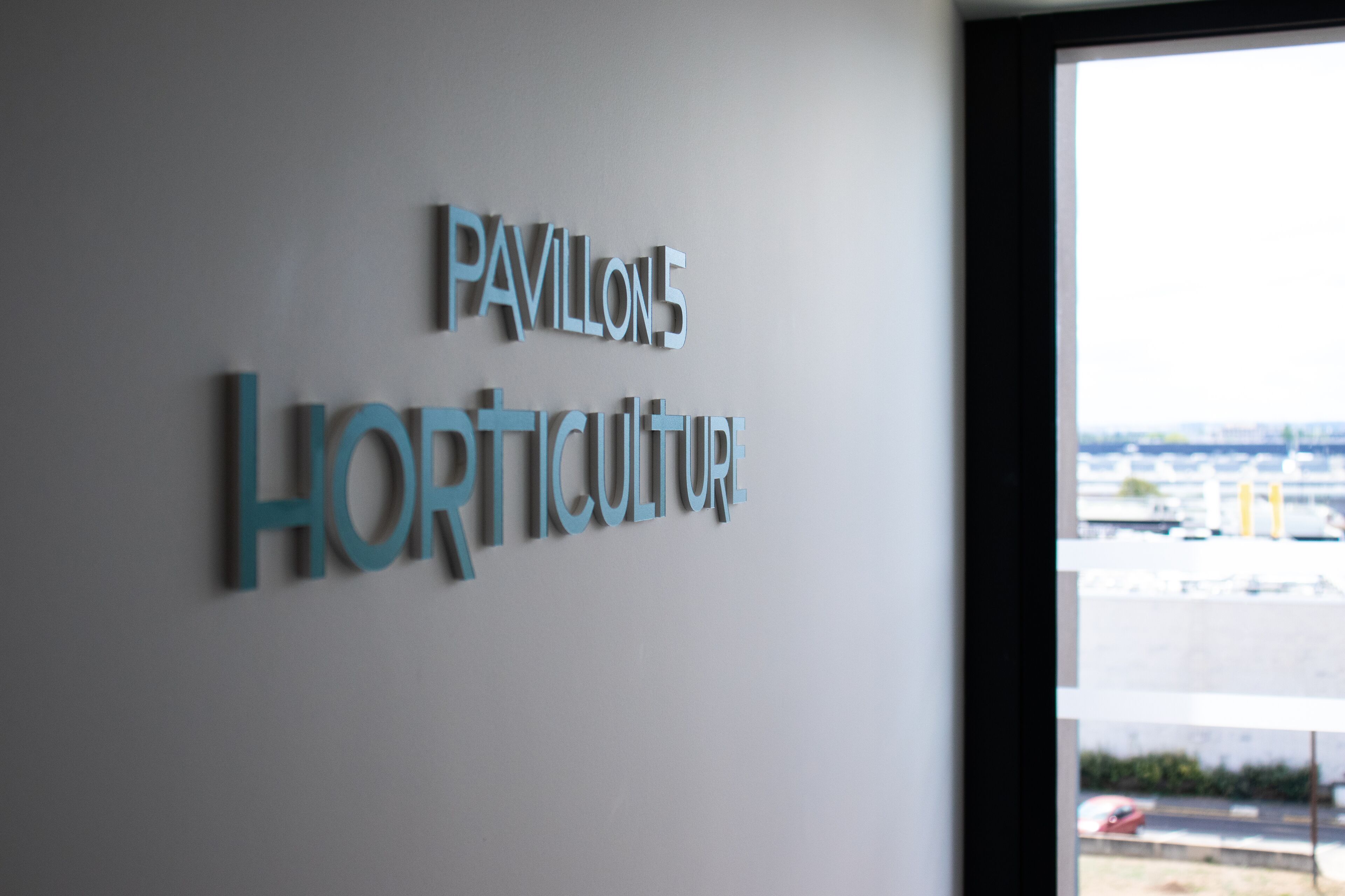 A sign with the words "Pavilion 5" and "Horticulture" on a wall.