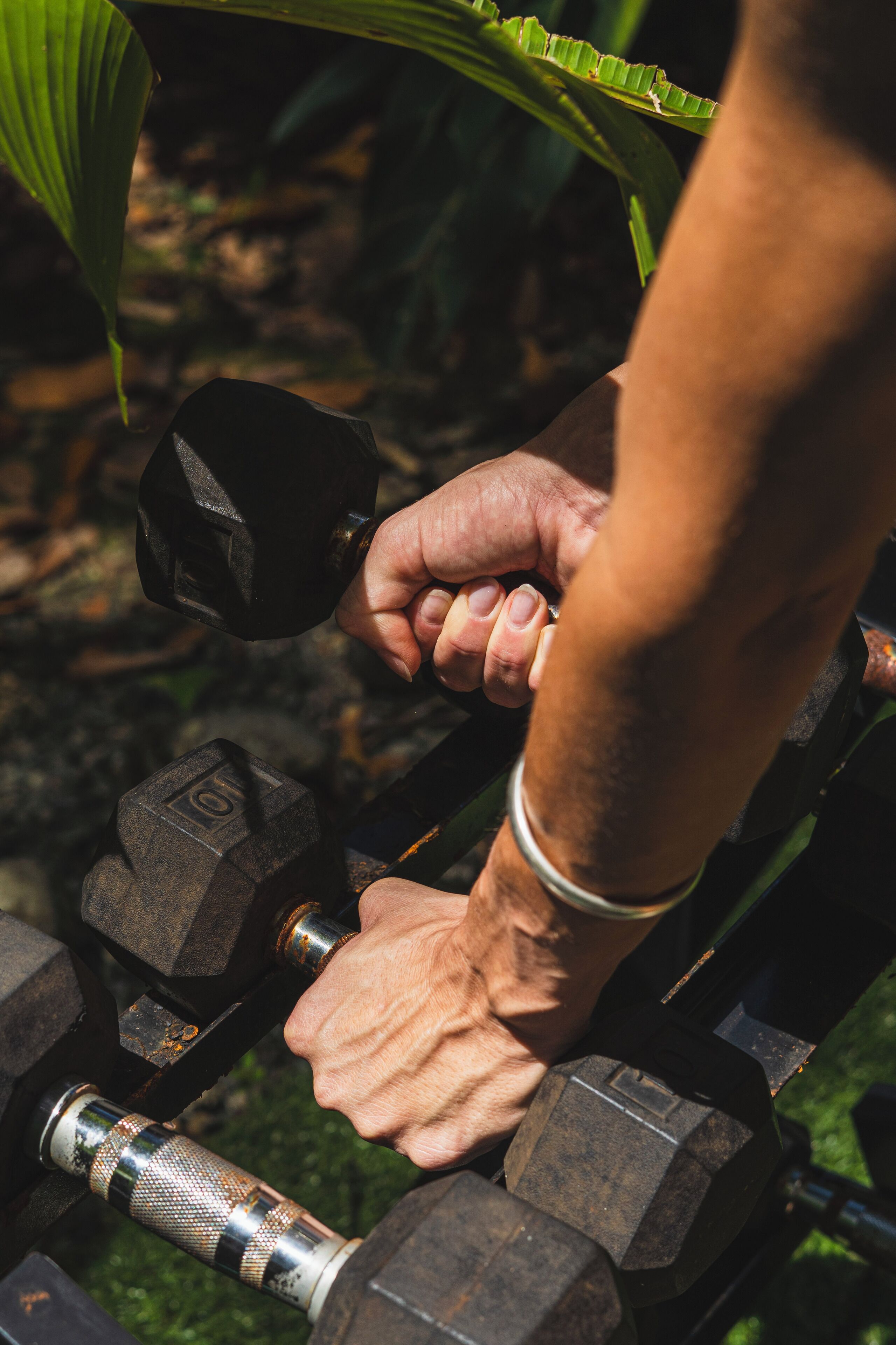 A close-up of a hand gripping a dumbbell.