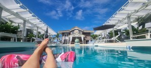 A pool area with a clear view of a building in the background.
