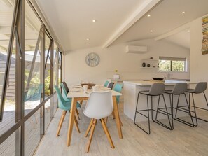 Enjoy meals in this spacious dining area with a large round table and comfortable seating for four.