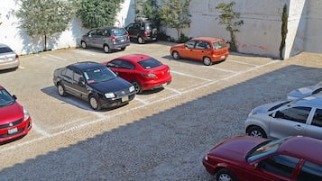 A parking lot with several cars parked in designated spaces.