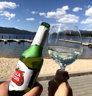 A bottle of Stella Artois beer and a glass of beer held by a person. - Lakefront condo w/ beach and seasonal heated pool (Mccall)